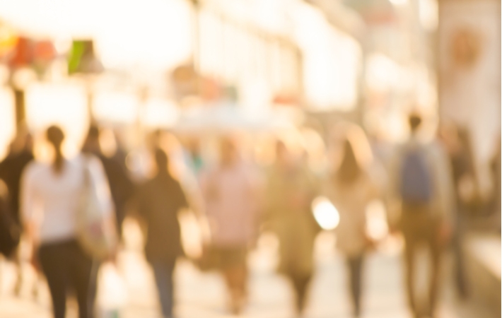 A group of city commuters blurred out as if someone who needs vision correction is looking in their direction