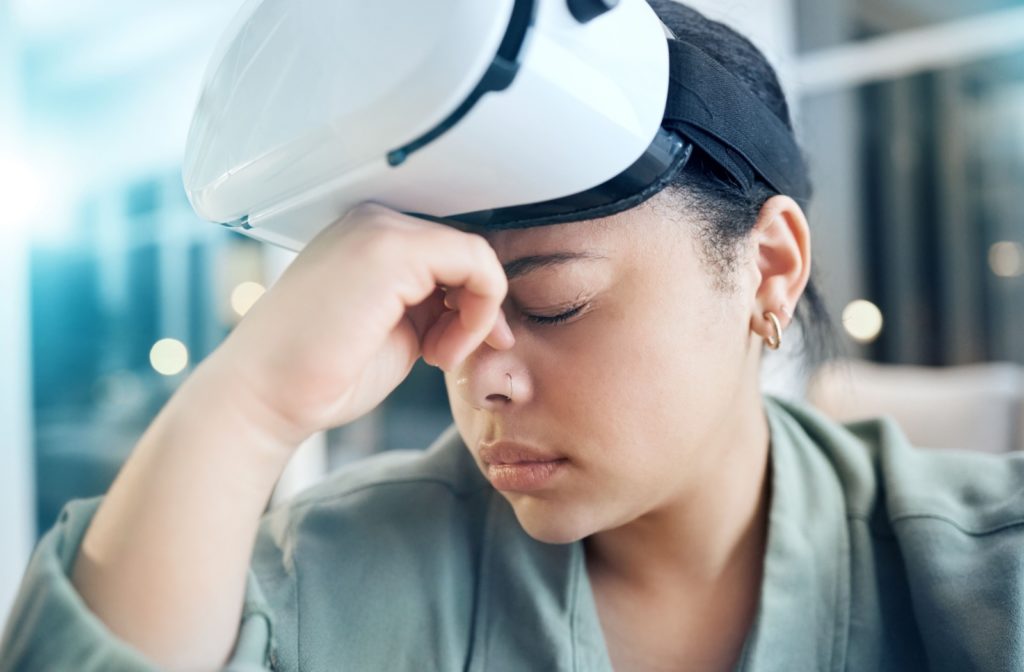 Woman experiencing eye strain after using a virtual reality headset.